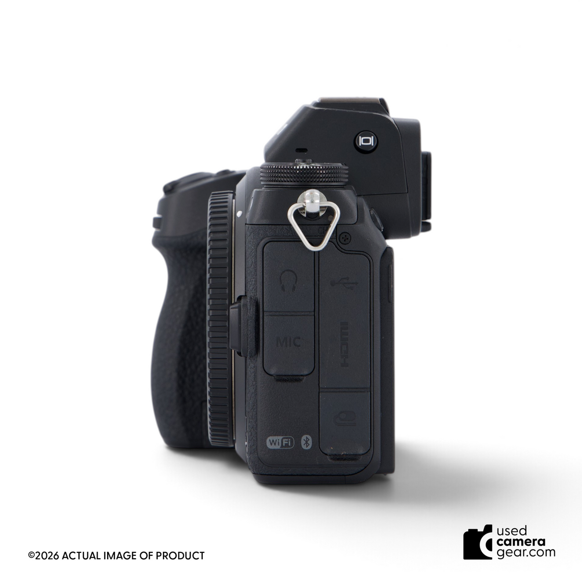 Side view of a black Nikon Z6 mirrorless camera body showing port covers and strap lug.