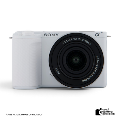 Used Sony ZV-E10 II white mirrorless camera with 16-50mm power zoom lens, front view.