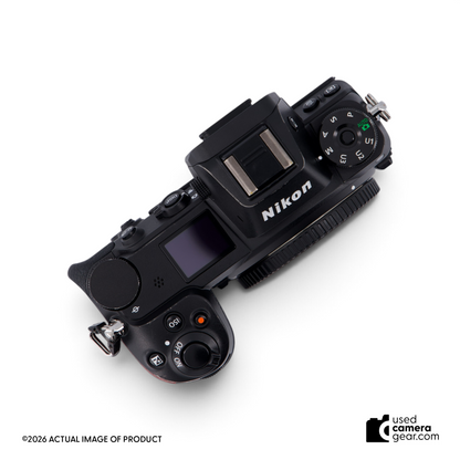 Top view of a used Nikon Z6 full-frame mirrorless camera body featuring dials and buttons on a black magnesium body.