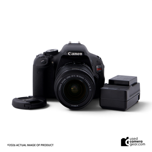 usedcameragear Canon Rebel T3i DSLR camera kit with 18-55mm lens, battery, and lens cap on a white background.