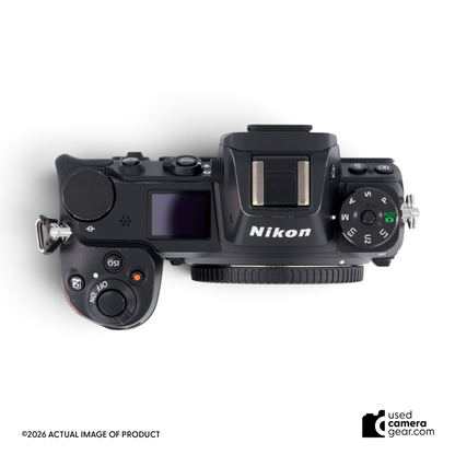 Top view of a black Nikon Z6 full-frame mirrorless camera body with mode dial and top LCD screen.